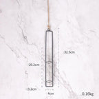 Hanging metal planter with dimensions on a marble background