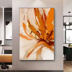 Abstract art painting with orange and beige colors on a wall in a modern interior setting.