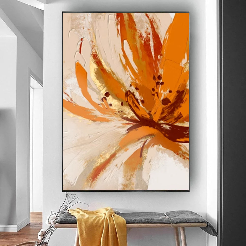 Abstract art piece with orange and beige colors on a wall above a bench.