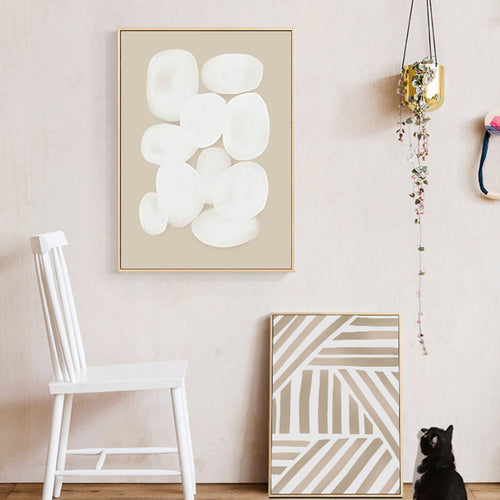 Modern interior with abstract wall art and a white chair.