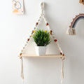 Hanging shelf with a plant on a white wall