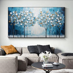 Hand painted textured wall art of trees with blue and white colors in a living room setting.