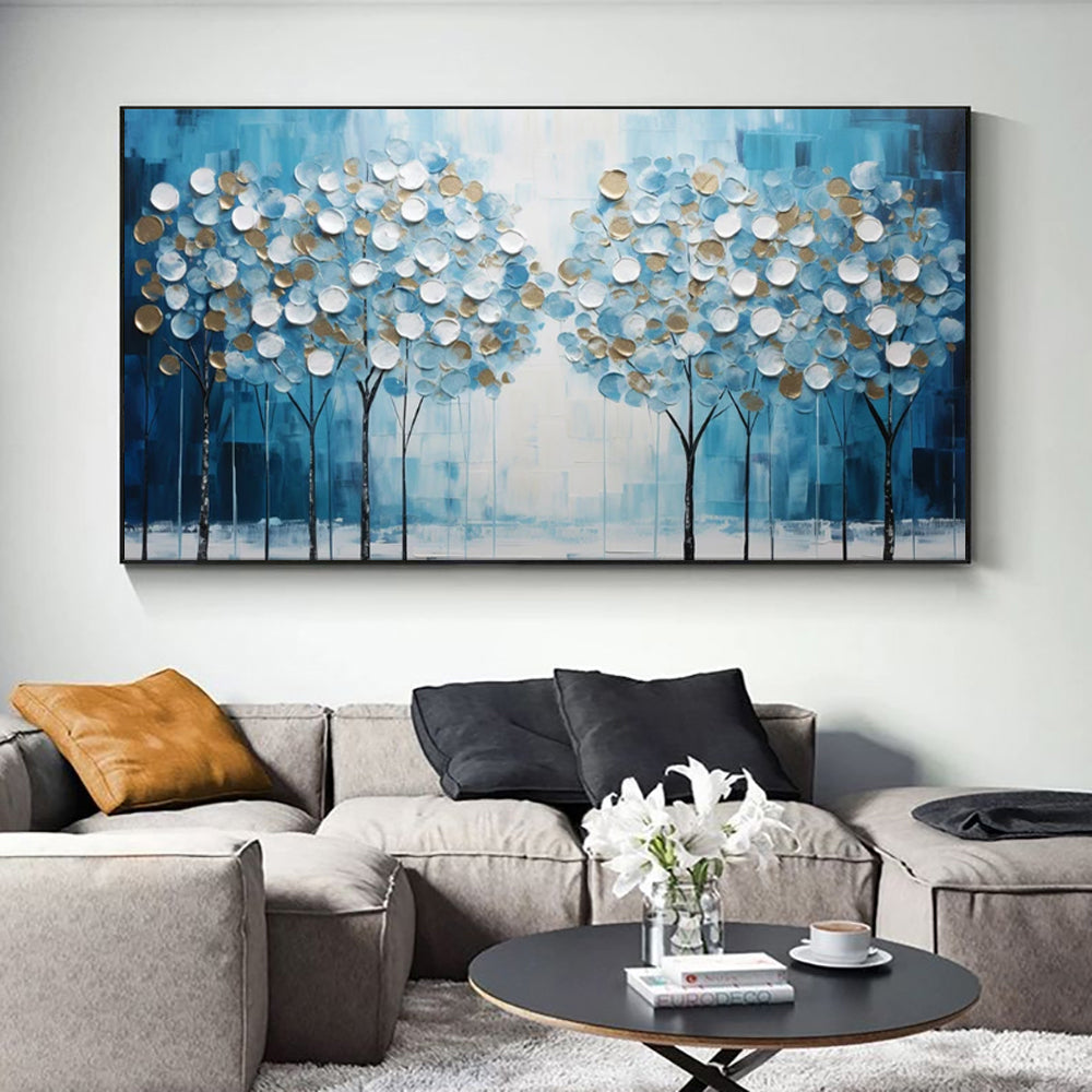 Hand painted textured wall art of trees with blue and white colors in a living room setting.