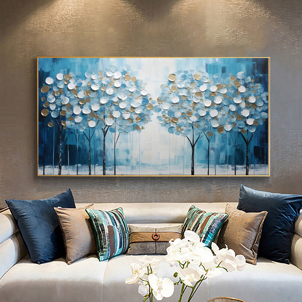 Abstract premium canvas painting of trees on a wall above a sofa with decorative pillows.
