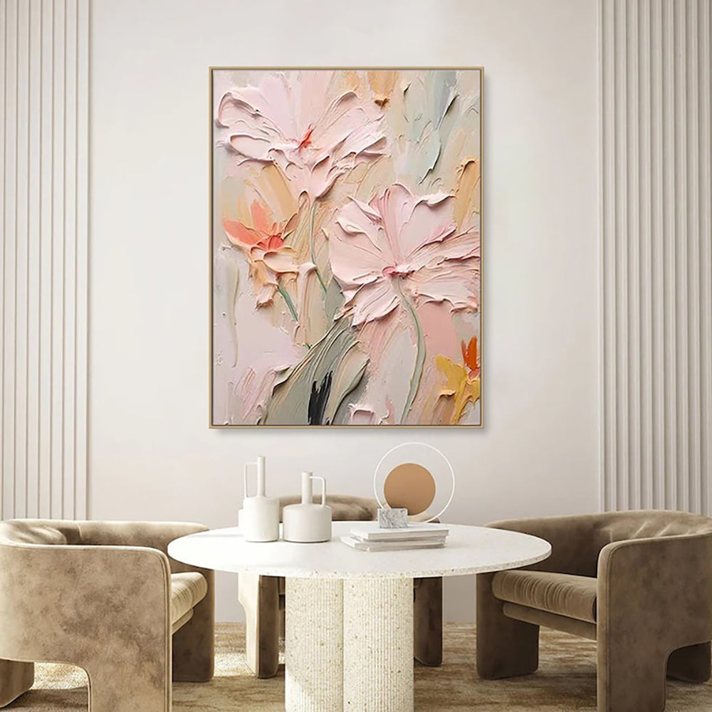 Abstract floral canvas painting on a living room wall above a round table with decorative items.