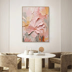 Abstract floral canvas painting on a wall above a modern round table with decorative items.