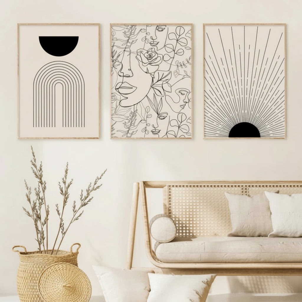 Three framed abstract artworks on a wall above a sofa with decorative elements.