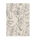 Beige rug with black line art of faces and floral patterns