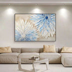 Living room with a large abstract painting of flowers on the wall above a beige sectional sofa. Celestia Bloom – Hand-Painted Blue & White Floral Canvas