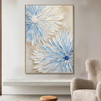 Framed artwork of blue and white floral designs on a wall above a chair. Celestia Bloom – Hand-Painted Blue & White Floral Canvas