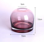 Pink glass vase with measurements on a white background