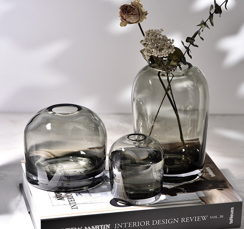 Set of glass vases on a book with a minimal background