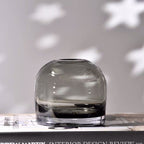 Clear glass vase on a surface with a neutral background