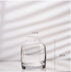 Clear glass vase with measurements on a light background