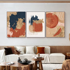 Abstract art prints on a wall above a sofa in a living room setting.