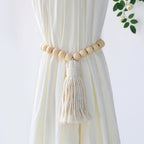 Curtain tieback with wooden beads and tassel on a white curtain