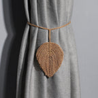 Leaf-shaped curtain tiebacks on a gray curtain