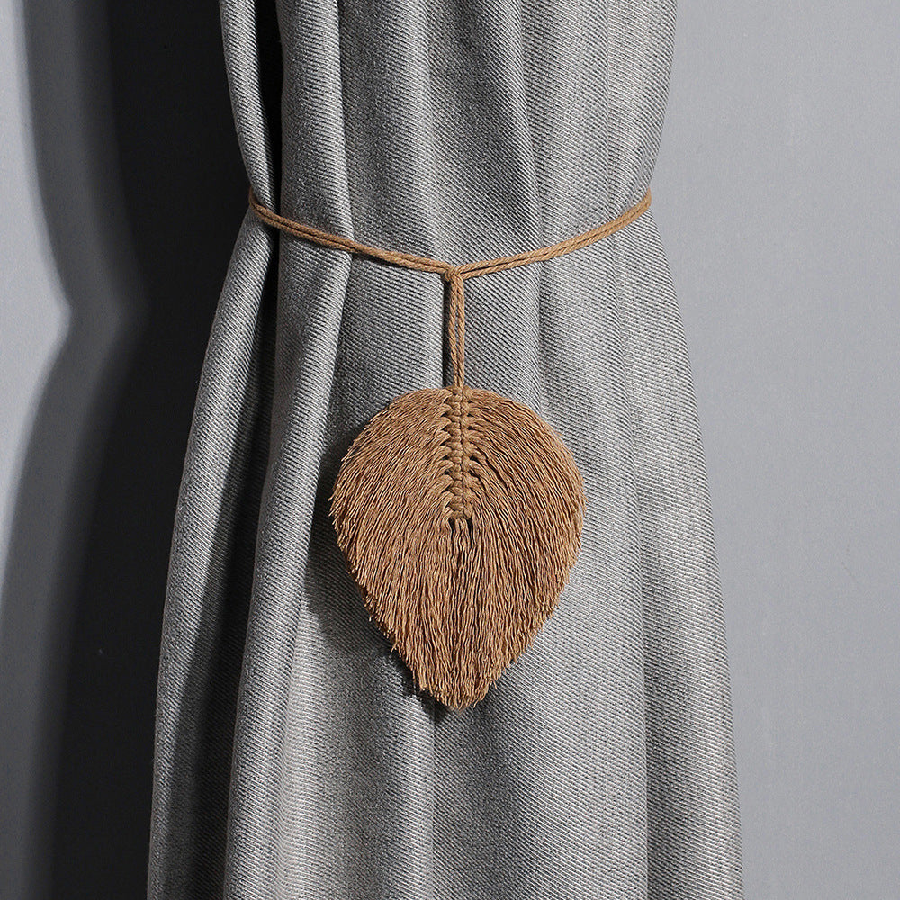 Leaf-shaped curtain tiebacks on a gray curtain