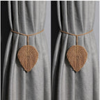 Leaf-shaped curtain tiebacks on a gray curtain