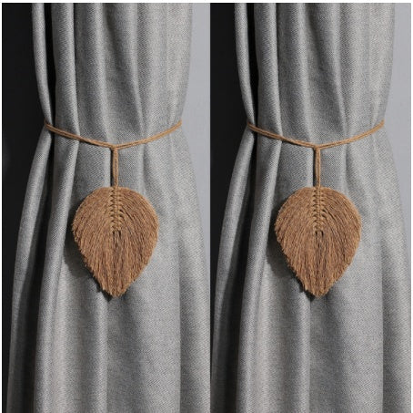 Leaf-shaped curtain tiebacks on a gray curtain