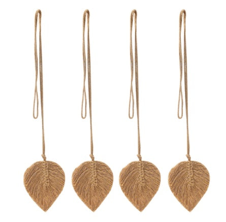 Four brown leaf-shaped ornaments hanging on strings against a white background