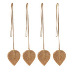 Four brown leaf-shaped ornaments hanging on strings against a white background