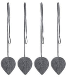 Four gray leaf-shaped ornaments with strings on a white background