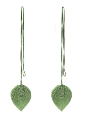 Pair of green leaf-shaped earrings on a white background