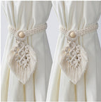 Two macrame curtain tiebacks with decorative elements on a white background