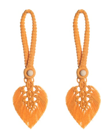 Orange earrings with heart-shaped designs on a white background