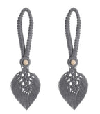Gray tassel earrings with leaf-shaped designs on a white background