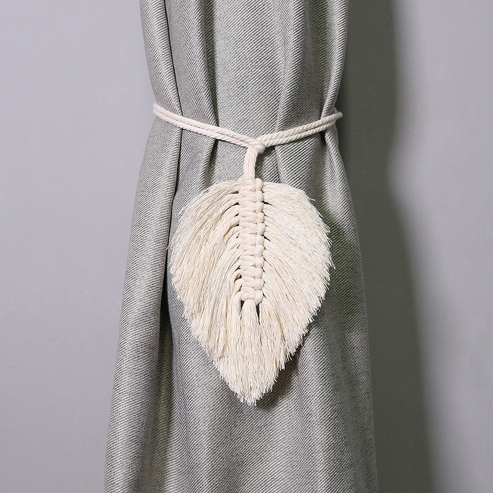 Macrame leaf tassel curtain tieback on a gray curtain against a gray background