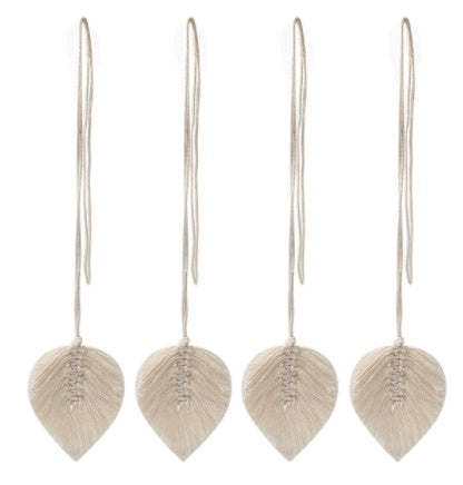 Pair of leaf-shaped earrings on thin wires against a white background