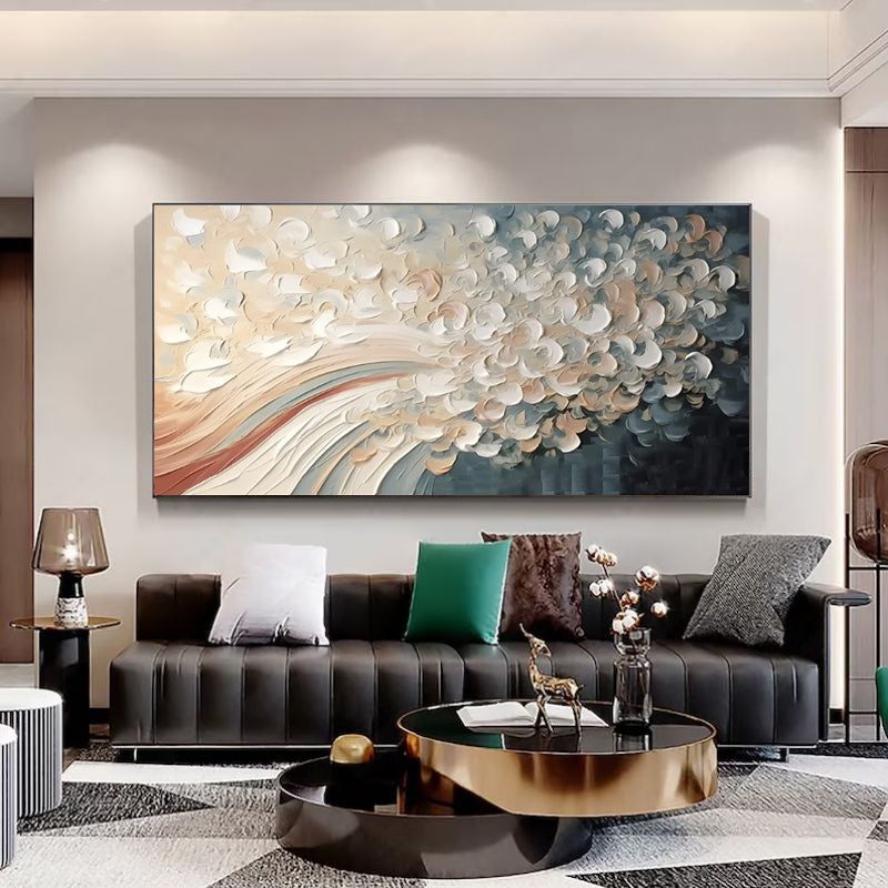 Modern living room with a large abstract painting on the wall, black sofa, and decorative items.