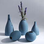 Set of blue ceramic vases on a light gray background