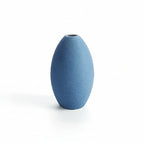 Blue textured vase with a measurement scale on a white background