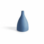 Blue ceramic vase on a white background with measurement scale