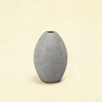 Gray textured vase on a white background with measurement lines.