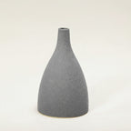 Gray textured vase with measurement lines on a white background