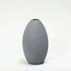 Gray textured vase on a white background with measurement lines.