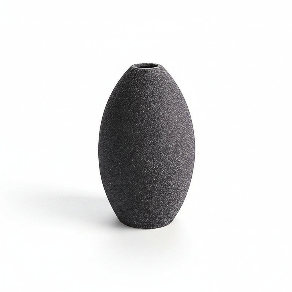 Black textured vase on a white background with measurement lines.