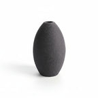 Black textured vase on a white background with measurement lines.