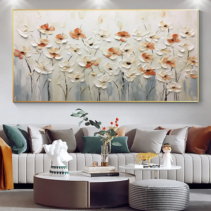 Decorative floral painting on a wall above a sofa with decorative items.