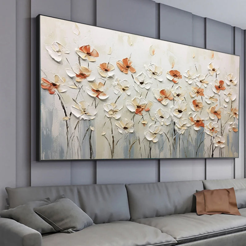 Abstract floral painting on a wall above a gray sofa with decorative pillows.
