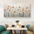 Dining room with a floral painting on the wall above a table.