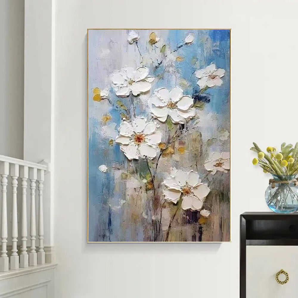 Abstract floral painting on a wall with a vase of flowers on a table.