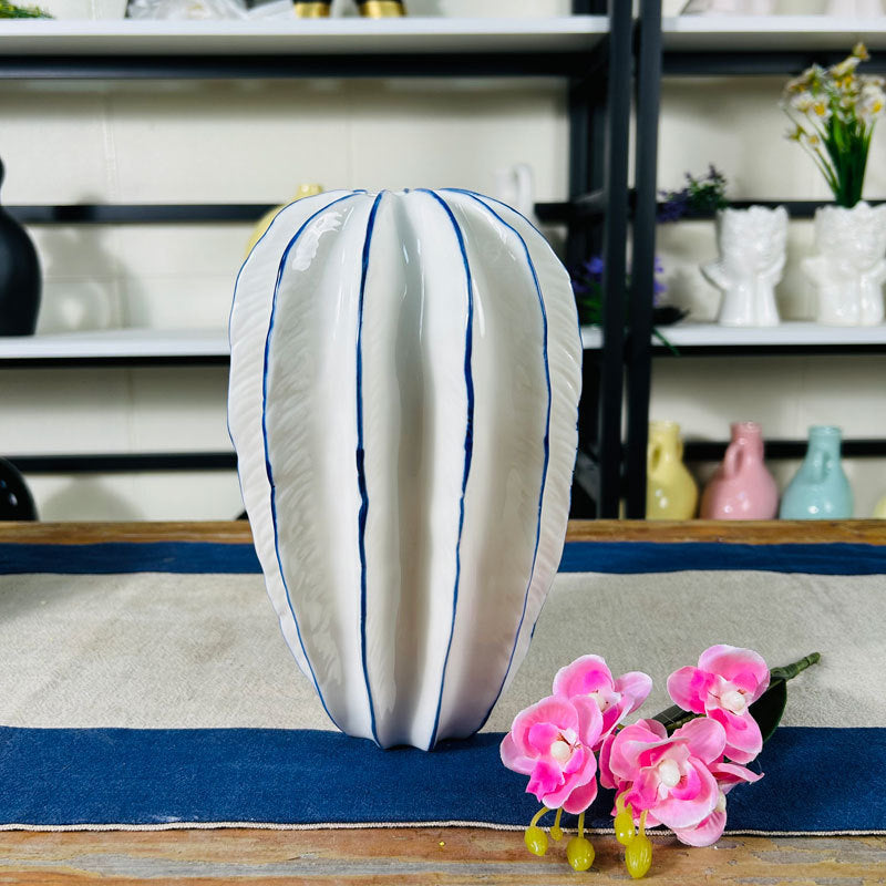 Modern elongated ceramic vase with cobalt blue-lined ridges