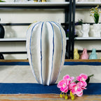 Modern elongated ceramic vase with cobalt blue-lined ridges