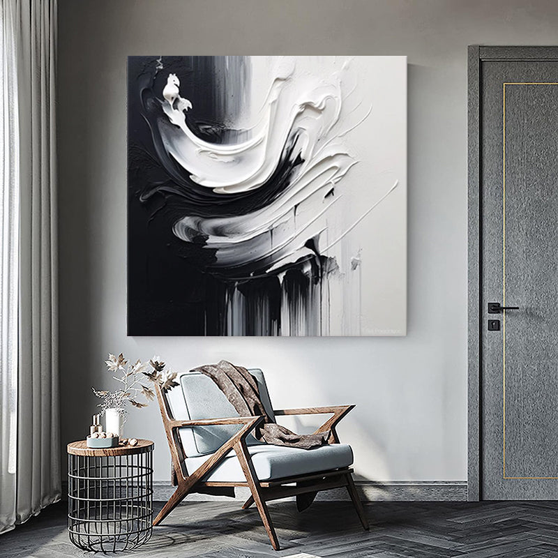 Modern interior with a chair, side table, and abstract painting on the wall.