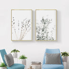 Two framed botanical prints on a wall above two blue chairs with striped cushions.